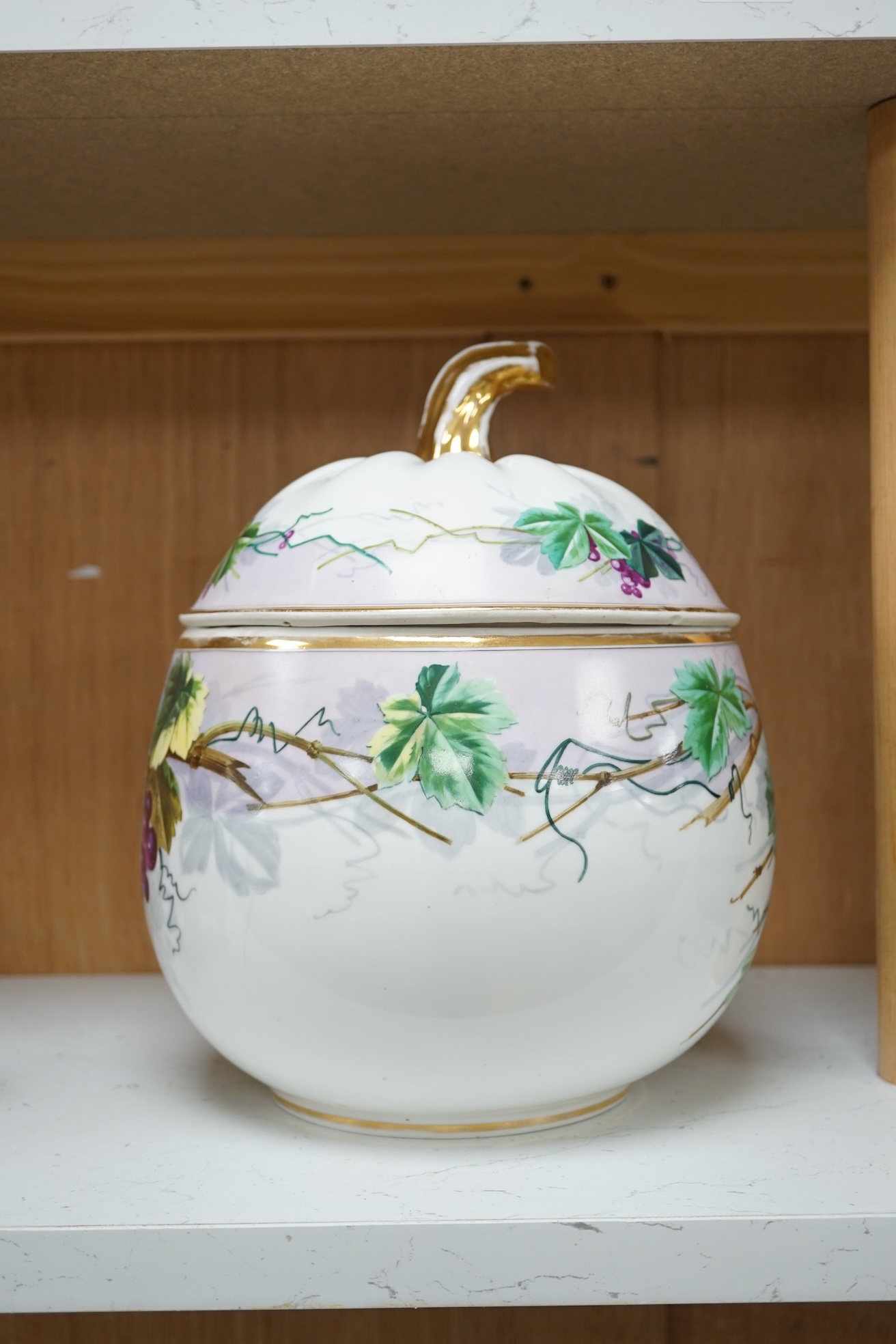 A Paris porcelain grape and vine painted punch bowl and cover, 27cm high. Condition - fair to good.